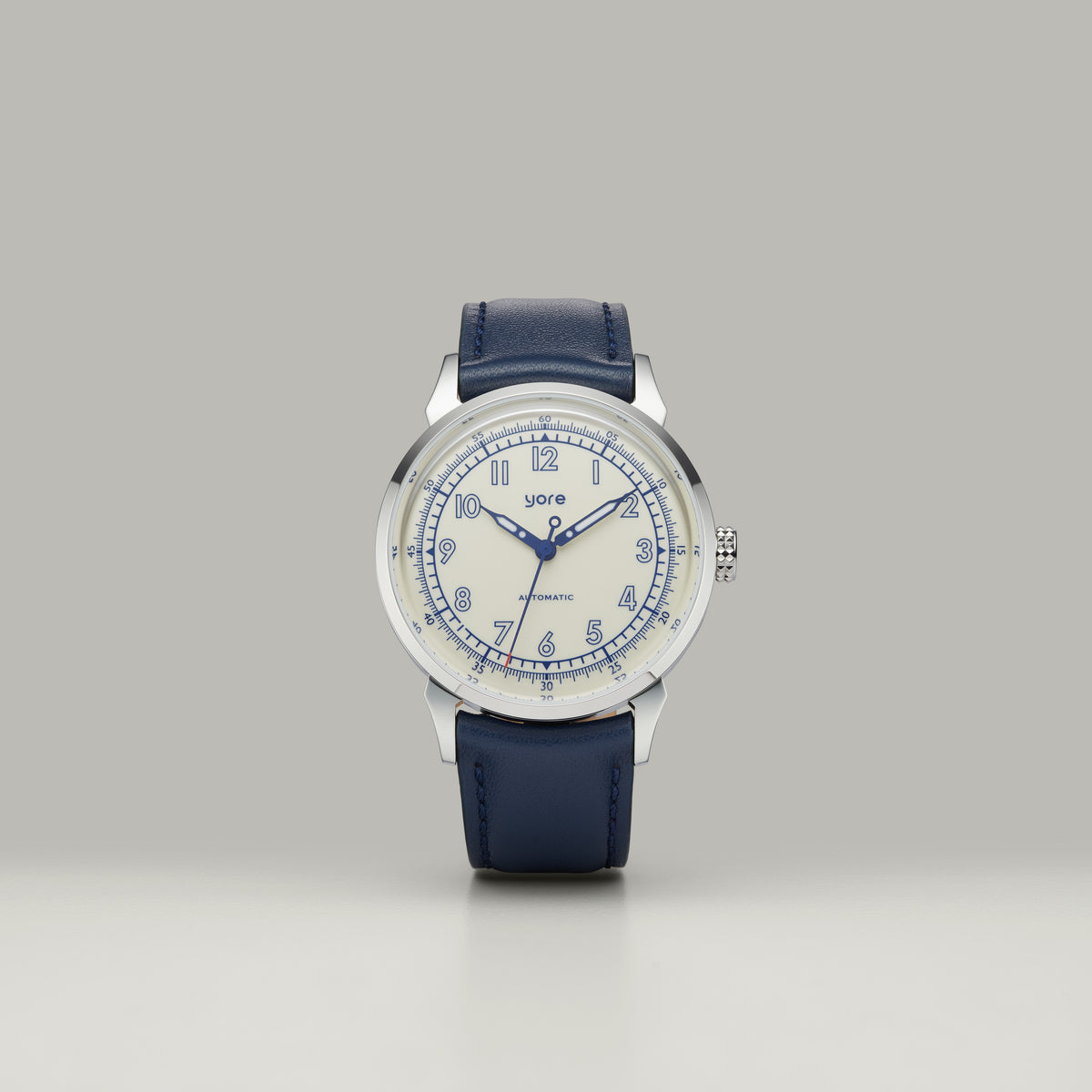 GYRE-0001 Dust field watch standing upright, ivory dial with blue markings and navy leather strap