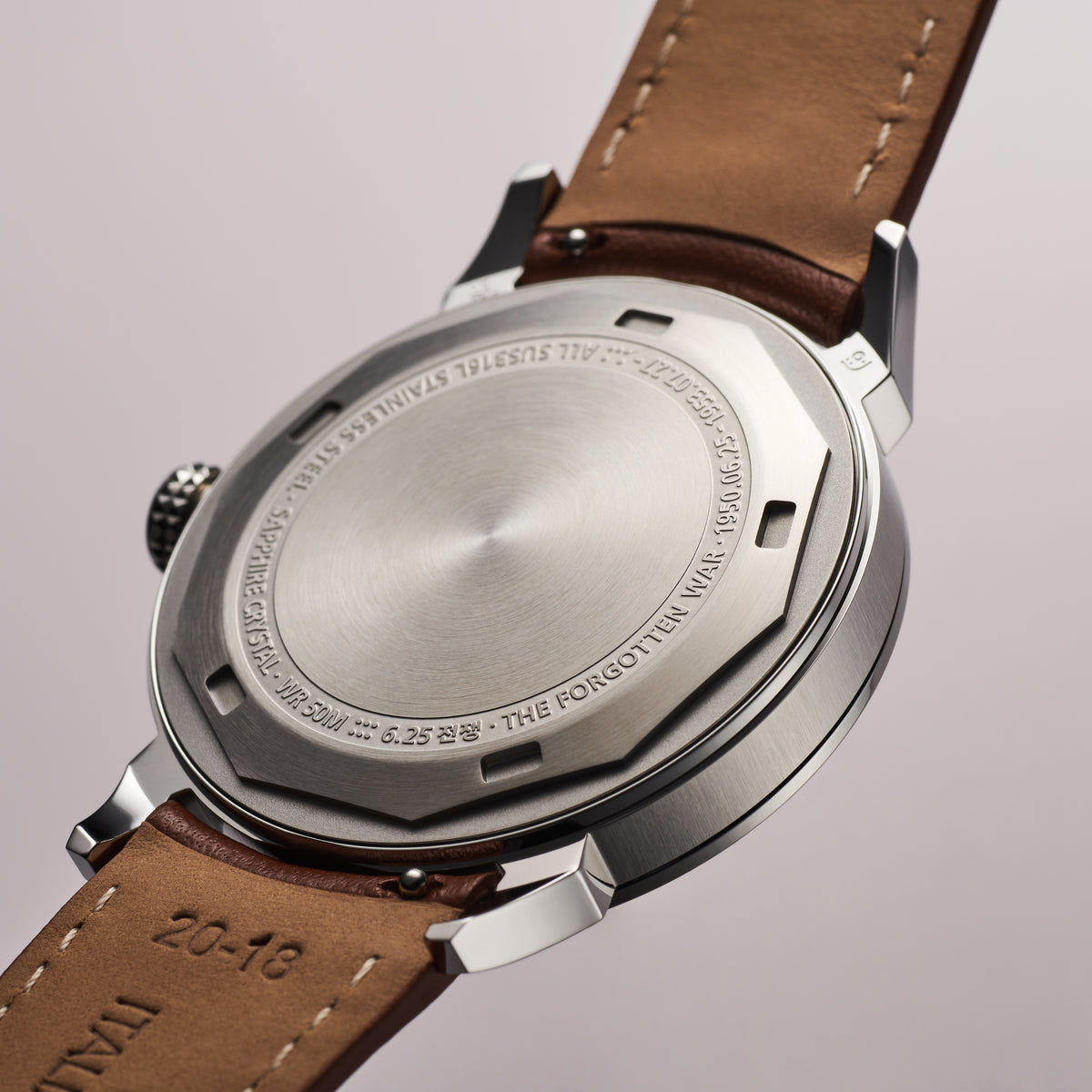 GYRE-0001 Night stainless-steel case back with engraved markings, brown leather strap showing tan underside