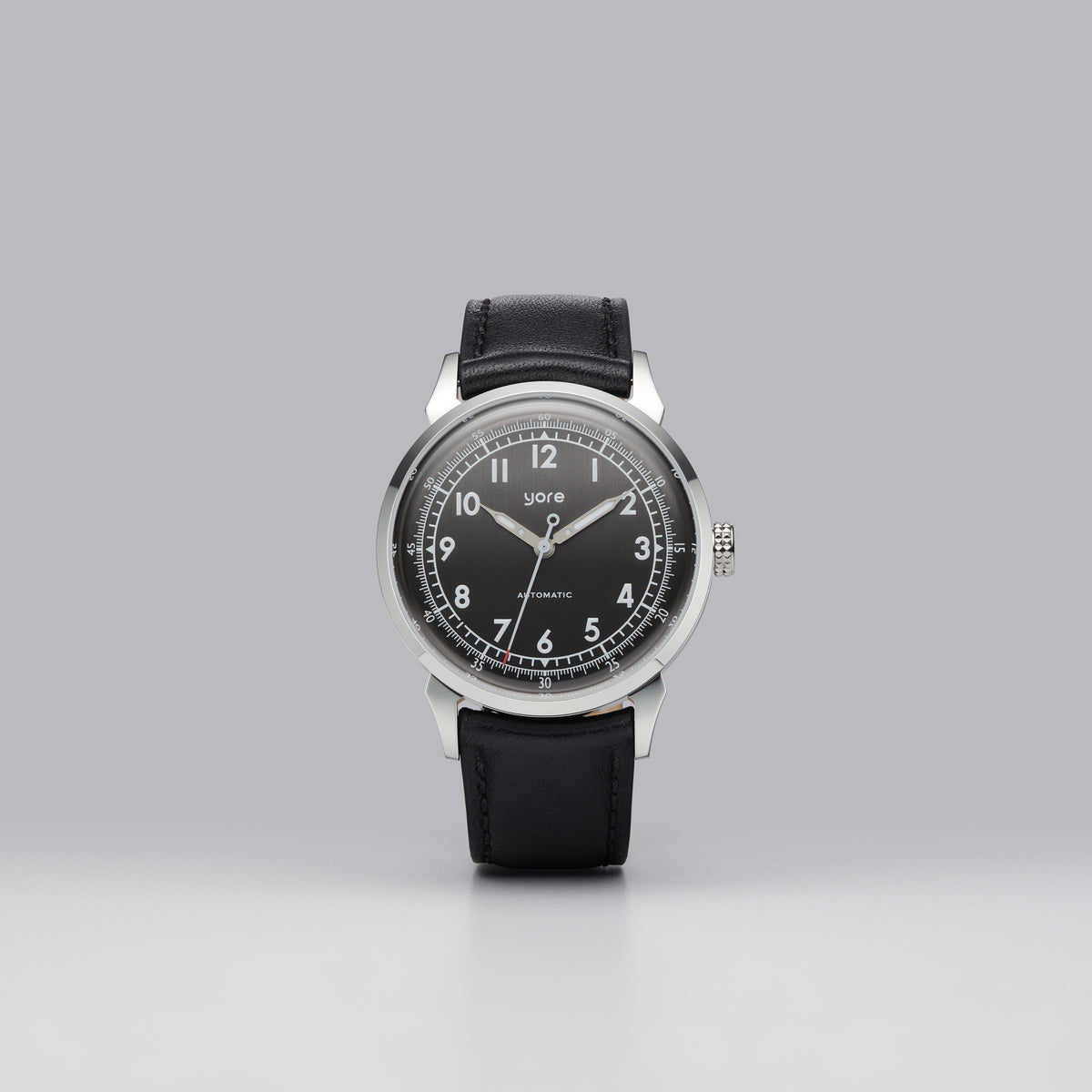 GYRE-0001 Smoke field watch standing upright, graphite dial with white numerals and black leather strap